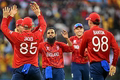 England's Adil Rashid (C) celebrates with teammates after taking the wicket of Sri Lanka's captain Dasun Shanaka during the 2026 ICC Men's T20 Cricket World Cup Super Eights match between Sri Lanka and England at Pallekele International Cricket Stadium in Kandy on February 22, 2026.