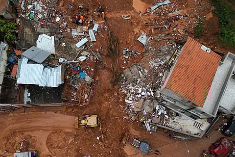 Rescue teams searching for victims amid the debris after a landslide caused by heavy rains in the Barrio Parque Jardim Burnier neighbourhood in Juiz de Fora, Minas Gerais State, Brazil.