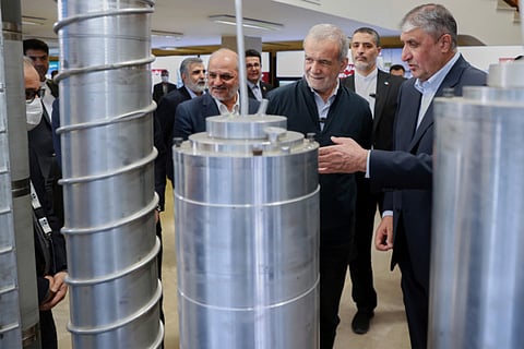 President Masoud Pezeshkian, second right, listens to the head of Atomic Energy Organization of Iran Mohammad Eslami as he visits an exhibition of Iran's nuclear achievements, in Tehran, on April 9, 2025