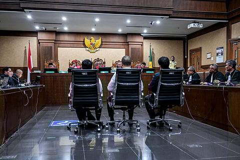 Dimas Ismoyo, former Senior Specialist for Feedstock Optimization at PT Kilang Pertamina Internasional, Gading Ramadhani, former Specialist for Feedstock Optimization at PT Kilang Pertamina Internasional, and Muhammad Kerry Adrianto Riza, former vice director of Product Optimization at PT Kilang Pertamina Internasional and son of the "gasoline godfather" Riza Chalid, attend a sentencing hearing in the Pertamina corruption case, at a courthouse in Jakarta on February 26, 2026.