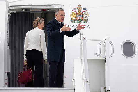 Canadian Prime Minister Mark Carney and his wife Diana Fox Carney board a government plane in Ottawa on Thursday, Feb. 26, 2026.