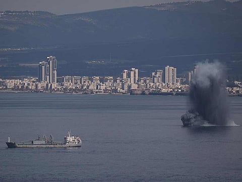 An incoming projectile explodes over the water as Israel issues a nationwide alert following its strikes on Iran, in Haifa Bay, northern Israel, Saturday, Feb. 28, 2026.