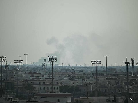Smoke rises from an area in the direction of Al Udeid Air Base, which houses the Qatar Emiri Air Force and foreign forces including the US, in Doha on February 28, 2026, following a reported Iranian strike.