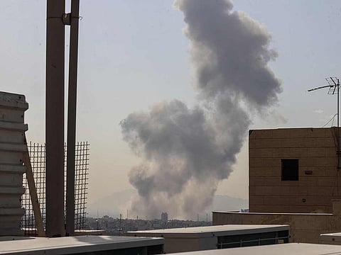 A plume of smoke rises following a reported explosion in Tehran on February 28, 2026.