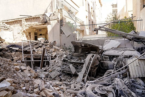 This picture obtained from Iran's ISNA news agency, shows the rubble and debris covering destroyed vehicle following a missile strike on a neighborhood of the Iranian capital Tehran on February 28, 2026.