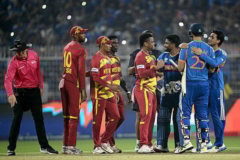 Umpire Alex Wharf gestures as West Indies' Roston Chase, Gudakesh Motie, Shamar Joseph and Shimron Hetmyer congratulate India's Sanju Samson, Shivam Dube and Abhishek Sharma for their team's win at the end of their 2026 ICC Men's T20 Cricket World Cup Super Eights match in the Eden Gardens, Kolkata on March 1, 2026.