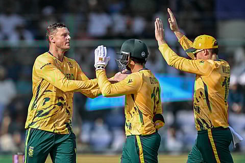 South Africa's George Linde (L) celebrates with teammates after taking the wicket of Zimbabwe's Dion Myers during the 2026 ICC Men's T20 Cricket World Cup Super Eights match between Zimbabwe and South Africa at the Arun Jaitley Stadium in New Delhi on March 1, 2026.