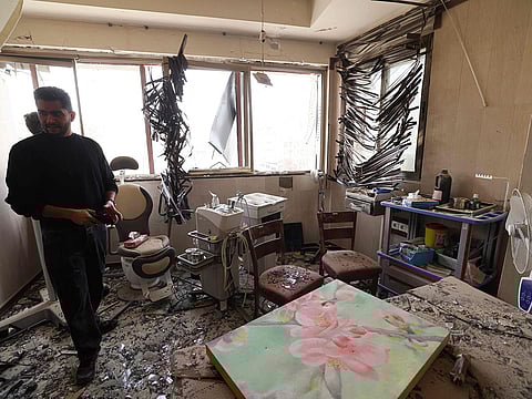 A man looks at the damage inside the Gandi Hospital, which was hit March 1, when a projectile struck a state TV communications tower and nearby buildings across the street, during the ongoing joint US-Israeli military campaign on the capital Tehran on March 2, 2026.