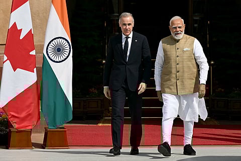 India's Prime Minister Narendra Modi (R) walks with his Canadian counterpart Mark Carney before their meeting at the Hyderabad House in New Delhi on March 2, 2026.