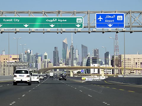 Vehicles drive along the highway leading to and from Kuwait City