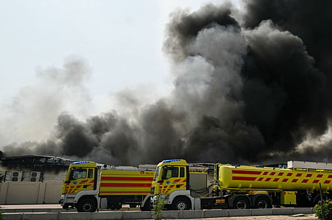 A plume of smoke rises from a reported Iranian strike in the industrial district of Doha on March 1, 2026.