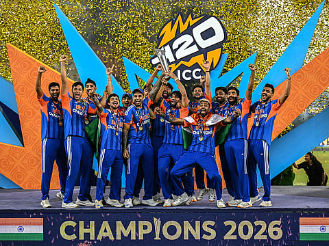 India's players celebrate with the trophy after winning the 2026 ICC Men's T20 Cricket World Cup final match against New Zealand at the Narendra Modi Stadium in Ahmedabad on March 8, 2026.