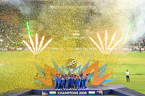 India's players celebrate with the trophy after winning the 2026 ICC Men's T20 Cricket World Cup final match against New Zealand at the Narendra Modi Stadium in Ahmedabad on March 8, 2026.