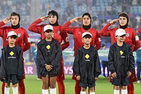 Iran players salute during their national anthem ahead of the Women's Asian Cup soccer match between Iran and the Philippines in Robina, Australia, Sunday, March 8, 2026. (Dave Hunt/AAP Image via AP)