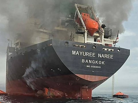This handout photo taken on March 11, 2026 shows smoke rising from the Thai bulk carrier 'Mayuree Naree' near the Strait of Hormuz after an attack.