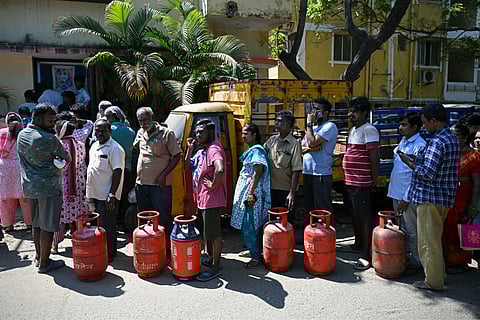 People queue to buy liquefied petroleum gas (LPG) cylinders for domestic use, at a gas agency office in Chennai on March 11, 2026.