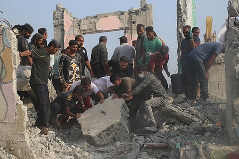 Rescue workers and residents search through the rubble in the aftermath of a strike on a girls' elementary school in Minab, Iran, Saturday, Feb. 28, 2026. (Abbas Zakeri/Mehr News Agency via AP)