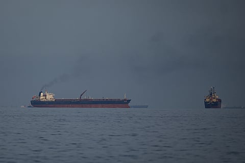 Oil tankers and cargo ships line up in the Strait of Hormuz as seen from Khor Fakkan, United Arab Emirates, Wednesday, March 11, 2026.