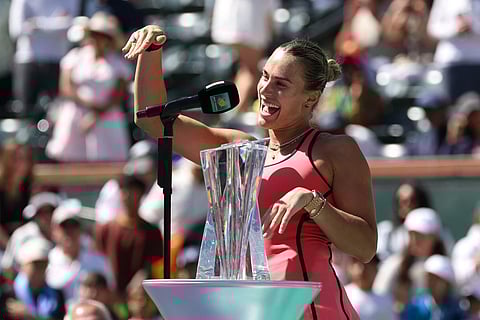 Aryna Sabalenka shows off her engagement ring while talking to the crowd after defeating Elena Rybakina to win the championship following their Women's Singles Finals match of the BNP Paribas Open at Indian Wells Tennis Garden