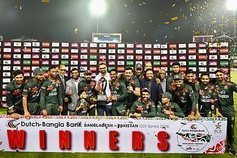 Bangladesh’s cricketers and support staff pose with the tournament trophy after the third one-day international (ODI) cricket match between Bangladesh and Pakistan at Sher-e-Bangla National Stadium in Mirpur on March 15, 2026.