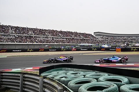 Red Bull Racing's Dutch driver Max Verstappen (L) and Alpine's French driver Pierre Gasly (R) drive during the Formula One Chinese Grand Prix at the Shanghai International Circuit in Shanghai on March 15, 2026.