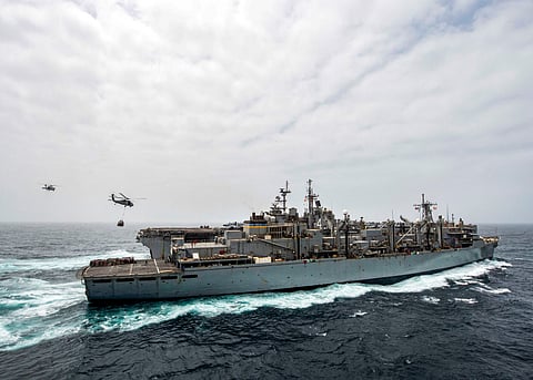 This handout picture released by the US Navy on July 14, 2019 shows the amphibious assault ship USS Boxer (LHD 4) receiving a vertical replenishment-at-sea from the fast combat support ship USNS Arctic (T-AOE 8) in the Arabian Sea.