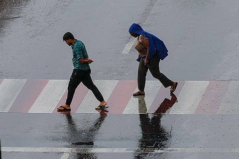 Residents brave the rain at Al Majaz, Sharjah.