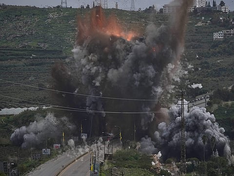 Smoke and flames rise from an Israeli airstrike that hit the Qasmiyeh Bridge near the coastal city of Tyre, Lebanon, Sunday, March 22, 2026.