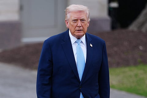 President Donald Trump walks to speak with reporters before departing on Marine One from the South Lawn of the White House, Friday, March 20, 2026, in Washington.