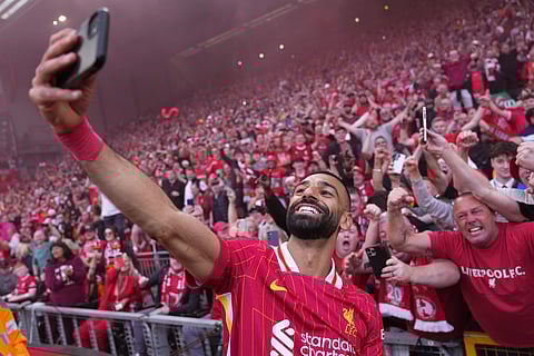 Liverpool's Mohamed Salah celebrates by taking a selfie with the Liverpool fans
