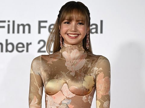 Thai rapper and singer Lisa, a member of the K-pop group Blackpink, arrives on the red carpet during the opening ceremony of the 30th Busan International Film Festival (BIFF) at the Busan Cinema Center in Busan on September 17, 2025.