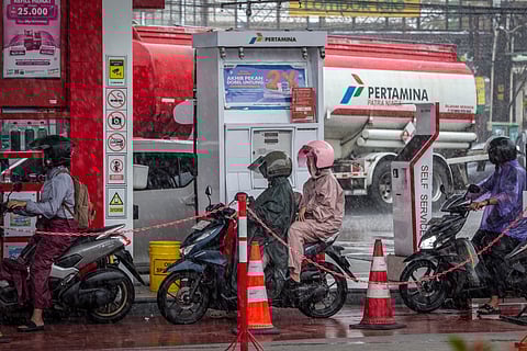 Motorcyclists queue to refuel at a gas station operated by Pertamina, Indonesia’s state-owned oil and gas company, as the closure of the Strait of Hormuz by Iran disrupts energy flows and global oil prices rise, prompting Indonesia to consider a weekly work-from-home policy to cut fuel use, in Yogyakarta on March 28, 2026.