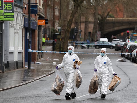 Police forensic officers take away full evidence bags on Friar Gate in central Derby, central England on March 29, 2026, following an incident the night before where a vehicle was driven into pedestrians.