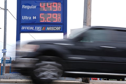 A vehicle passes a gasoline price board at a filling station in Philadelphia, Friday, March 27, 2026.