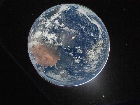 Earth as seen through the Orion spacecraft’s window, photographed by NASA astronaut Reid Wiseman, commander of Artemis II, on April 2, 2026, after completing the translunar injection burn.