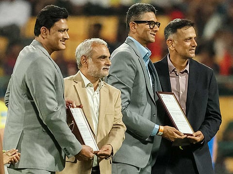 Former Indian cricket players Anil Kumble (L) and Rahul Dravid (R) pose for a photograph as they unveil field ends named after them before the start of the 2026 IPL match between RCB and CSK at the M Chinnaswamy Stadium in Bengaluru on April 5, 2026.
