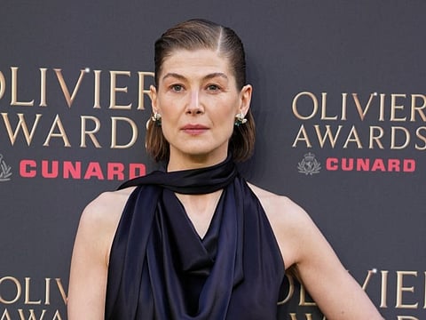 British actress Rosamund Pike poses on the green carpet upon arrival to attend The Olivier Awards at the Royal Albert Hall in central London on April 12, 2026.