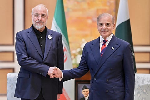 Iran's Parliament Speaker Mohammad Bagher Ghalibaf, left, with Pakistani Prime Minister Shehbaz Sharif prior to their meeting, in Islamabad, Pakistan, Saturday, April 11, 2026.