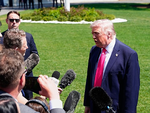 President Donald Trump speaks with reporters before departing on Marine One from the South Lawn of the White House.