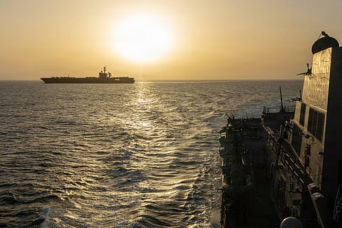 This US Navy handout photograph released on April 17, 2026, by US Central Command Public Affairs shows USS Abraham Lincoln (L) conducting blockade operations in the Arabian Sea on April 16, 2026.
