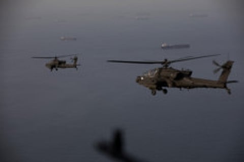 AH-64 Apaches flying above the Strait of Hormuz during a patrol on April 17, 2026.