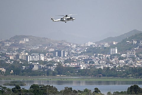 A helicopter flies over the Red Zone area in Islamabad on Monday (April 20, 2026), amid heightened security measures ahead of anticipated US-Iran peace talks.