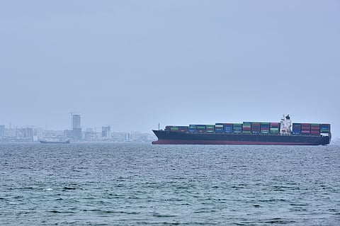 A container ship is seen in the Strait of Hormuz off the coast of Qeshm Island, Iran, Saturday, April 18, 2026.