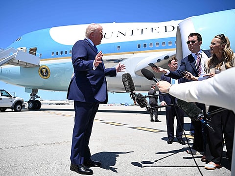 US President Donald Trump speaks to the traveling press before boarding Air Force One at the Palm Beach International Airport on April 25, 2026 in West Palm Beach, Florida.