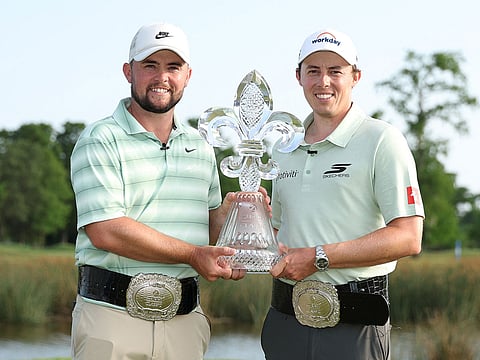 Alex Fitzpatrick (L) of England and Matt Fitzpatrick of England pose with the trophy on the 18th green after winning the Zurich Classic of New Orleans 2026 at TPC Louisiana