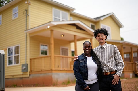 Home owners Phileena Daniel and Oswaldo Herrera pose for a photo in Langston Park, April 13, 2026, in Atlanta. (AP Photo/Mike Stewart)