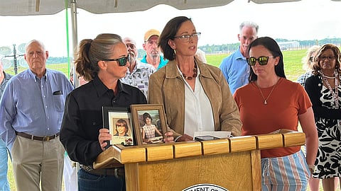 Lynn Cobb, center, speaks about her younger sister Cynthia Driggers while Driggers' niece Tanya Clement holds up photos of Cynthia Driggers after her killer, James Ernest Hitchcock, was executed on Thursday, April 30, 2026, in Starke, Fla. (AP Photo/Jeffrey Collins)