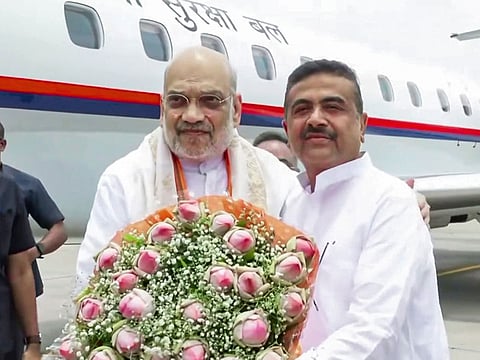 Union Home Minister Amit Shah receives a warm welcome from BJP leader Suvendu Adhikari upon his arrival, in Kolkata on Friday, May 8, 2026.