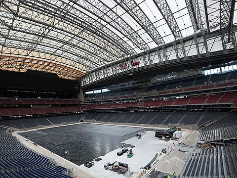 Workers install the first layer of the new playing surface at Houston Stadium, on Friday, May 8, 2026, in Houston, ahead of the 2026 FIFA World Cup soccer matches.