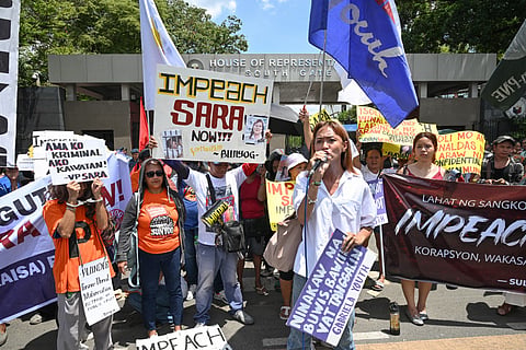 Protesters from progressive groups hold placards during a protest in support of the impeachment of Philippine Vice-President Sara Duterte in front of the Congress building in Quezon City, Metro Manila on May 11, 2026.